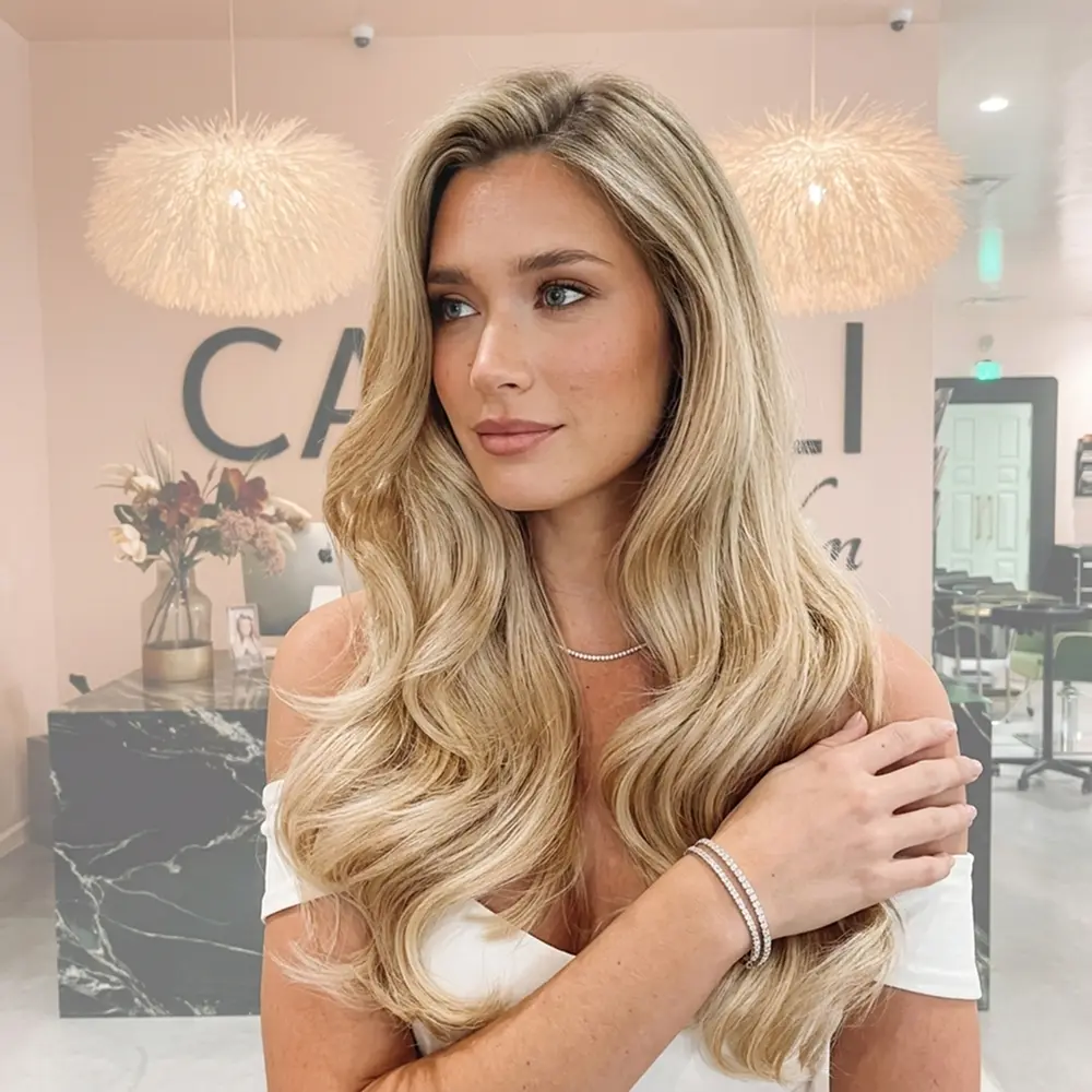 Tape-in hair extensions for seamless length at Capelli Salon Dallas